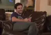 Man sitting on a brown couch